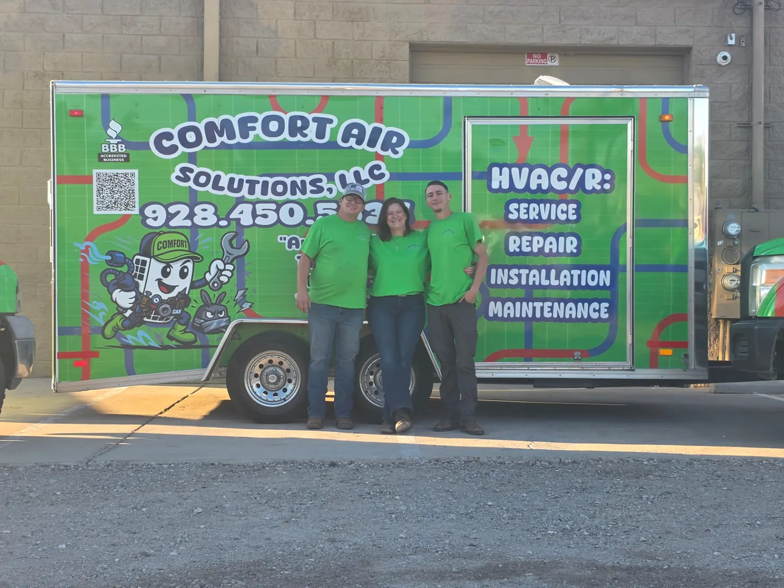 Three members of the Comfort Air Solutions team in front of the company service trailer
